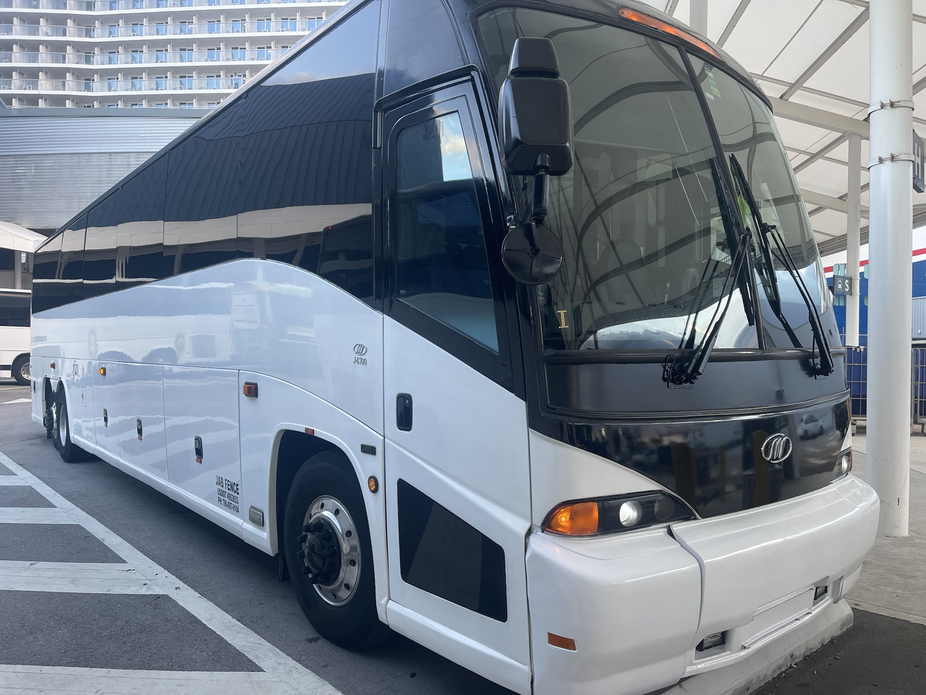 Coach bus ready for charter service at a pickup area